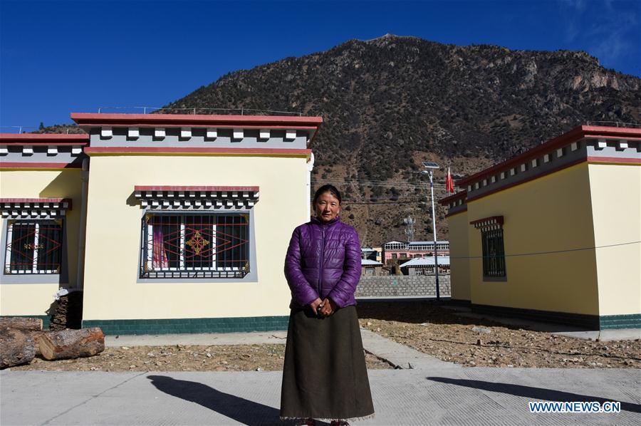 impoverished villagers in china"s tibet move into