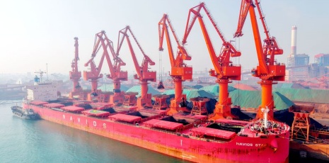 Imported iron ores are being unloaded in Qingdao Port