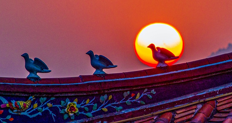 Sunset glow reflected on cornices of an ancient temple