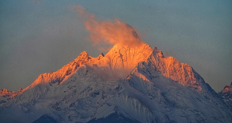 Sunshine covers the mountaintop of Meili Snow Mountain