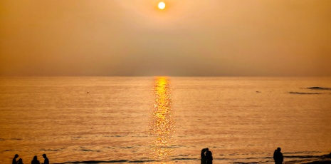 Sunrise paints the sea with golden hues